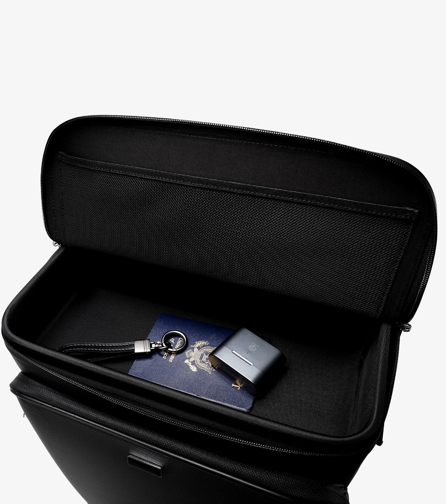 Black travel case with a passport and card inside on a white background