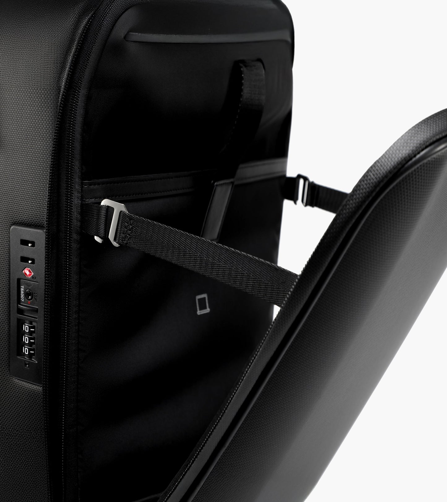 Black suitcase with visible straps and power outlets on a white background