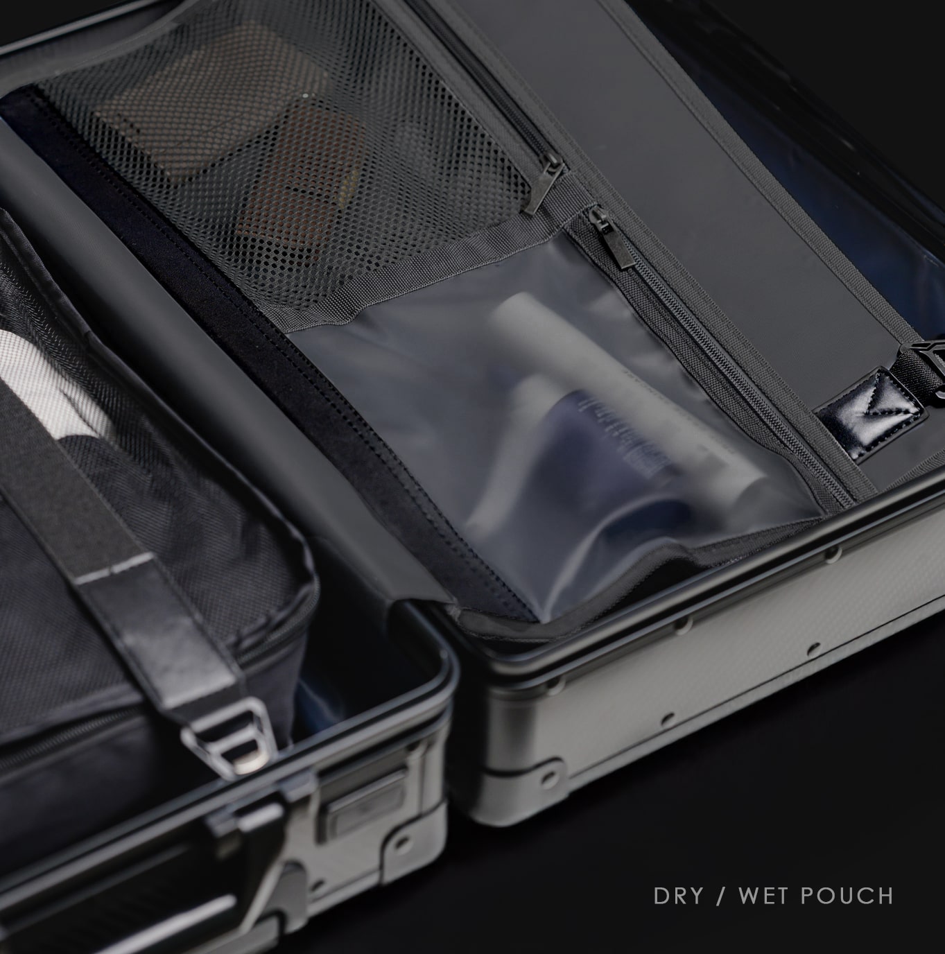 Open suitcase with a dry/wet pouch inside, on a black background